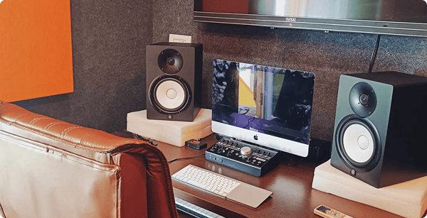 a recording studio with monitors and speakers