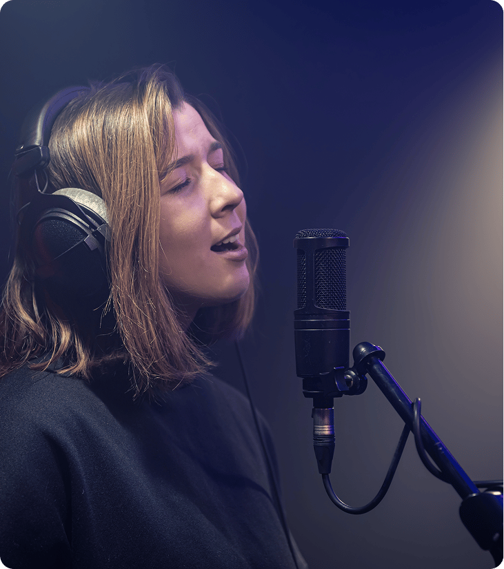 a woman singing into a microphone