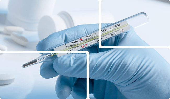 a hand holding a thermometer