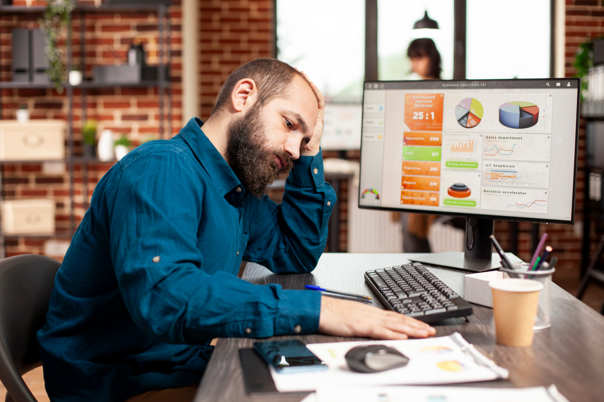 Frustrated business owner managing multiple order spreadsheets.