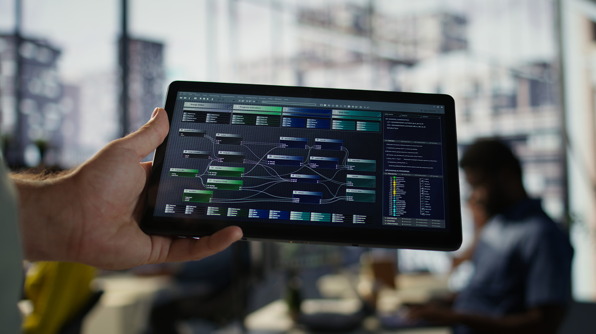 Engineer using a tablet for aircraft maintenance diagnostics, illustrating MRO software in action.