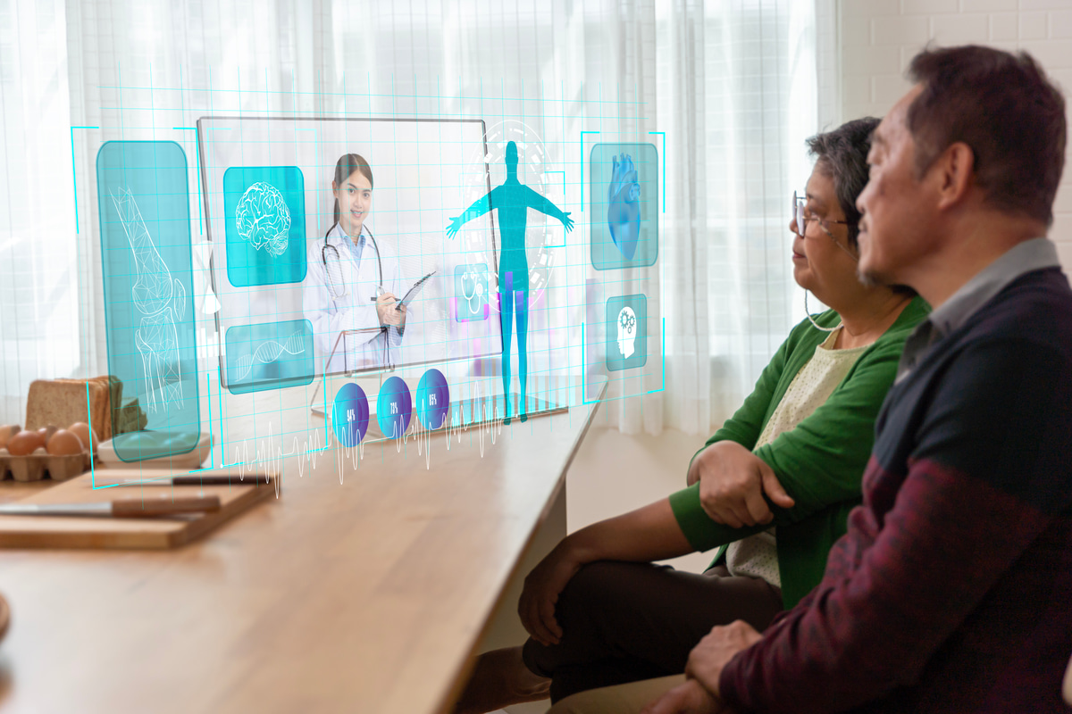 Patient engaging in a telehealth video call with a doctor on a laptop.