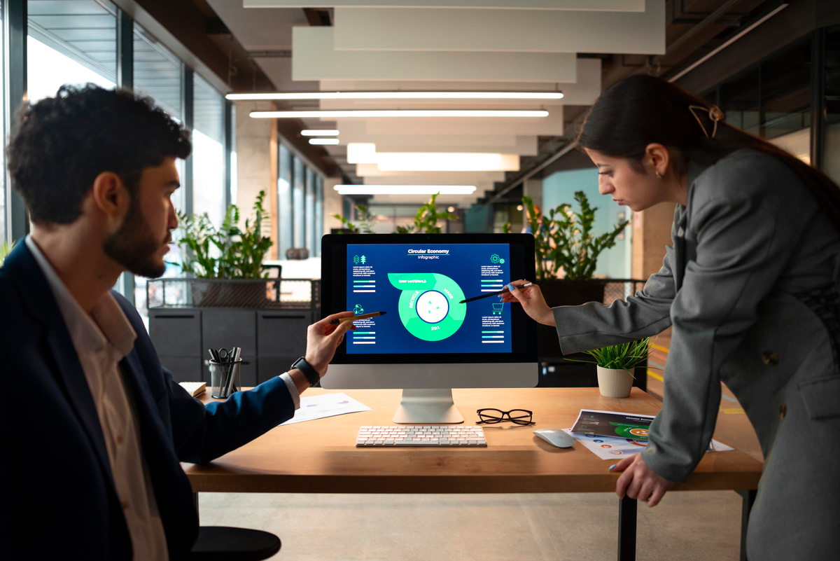 a man and a woman looking at a computer screen