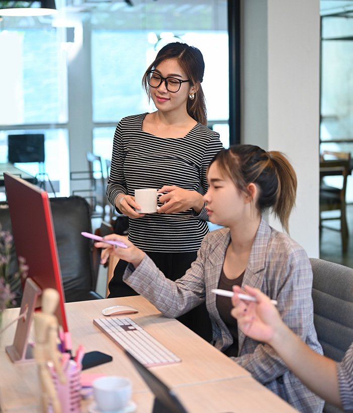 a group of people working at a desk in an office