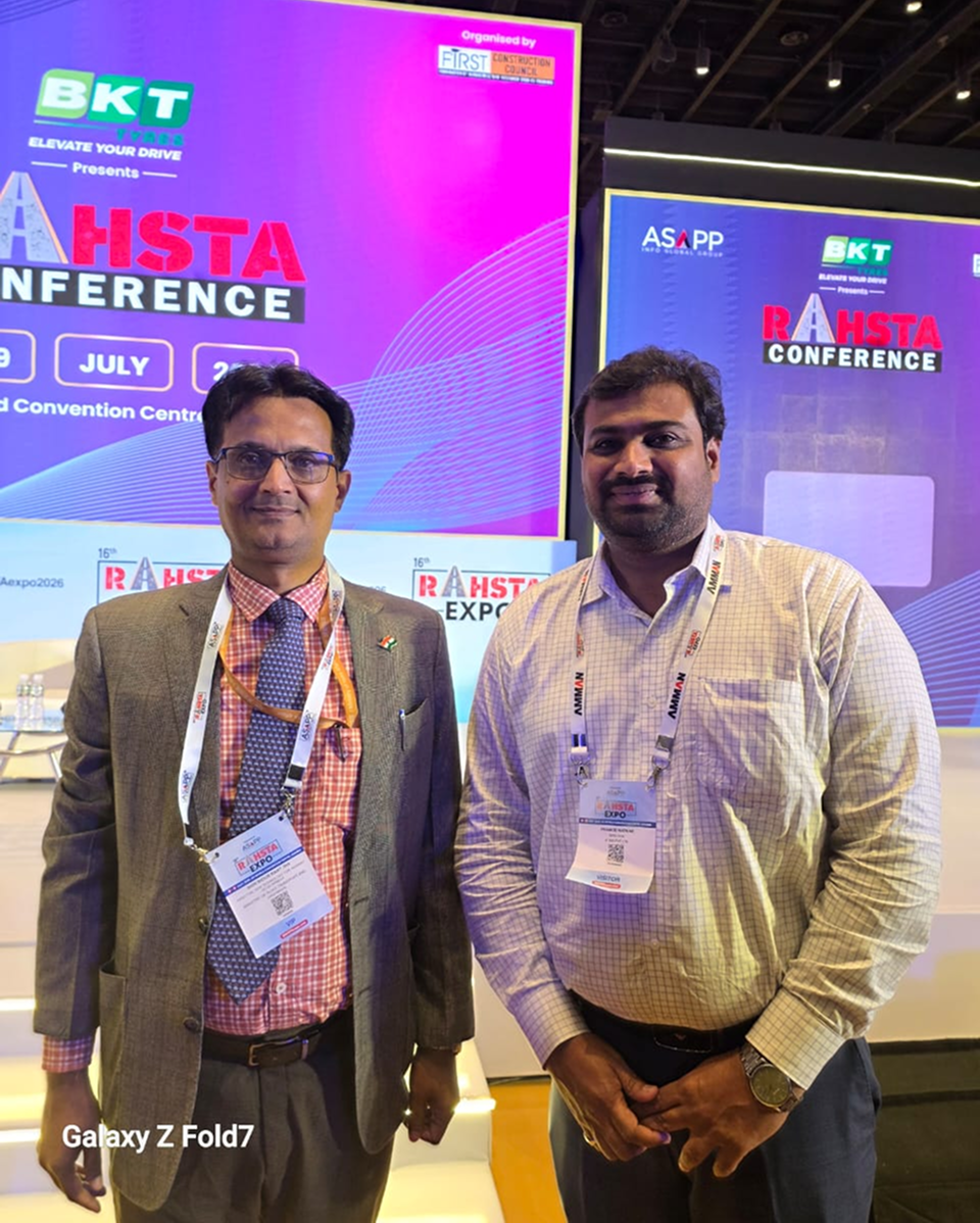 two men standing in front of a conference booth