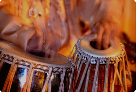 an indian man playing the tabla