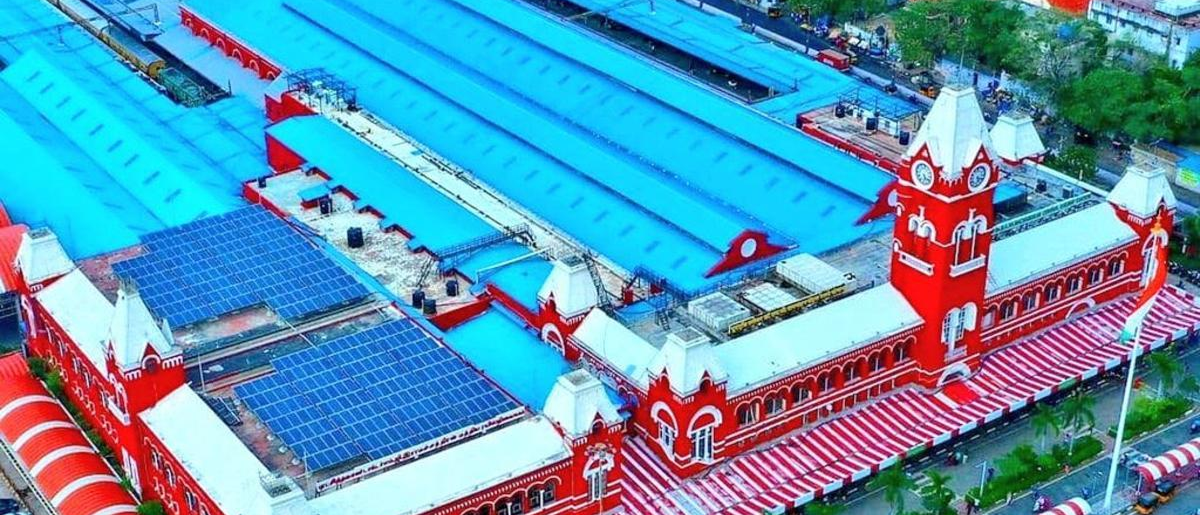 an aerial view of a red building with solar panels