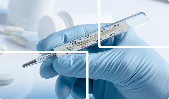 a hand holding a thermometer