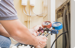 a man is working on an air conditioner