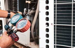 a man is working on an air conditioner