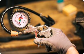 a man is holding a pressure gauge